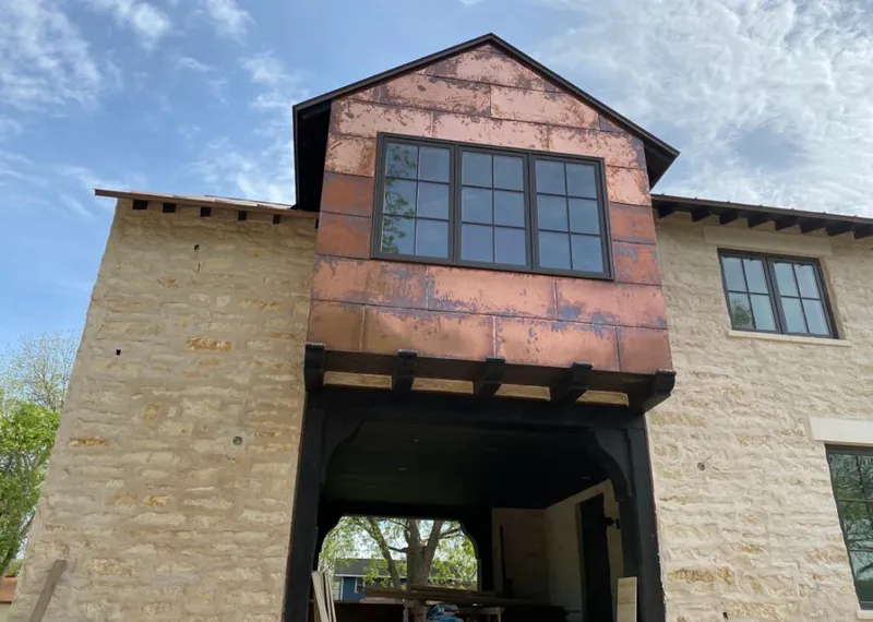 Copper metal panel facade on a stone building for Skylight Installation in Hoffman Estates