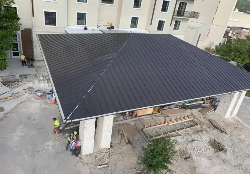 Metal roofing installation team working on a commercial building in Hoffman Estates