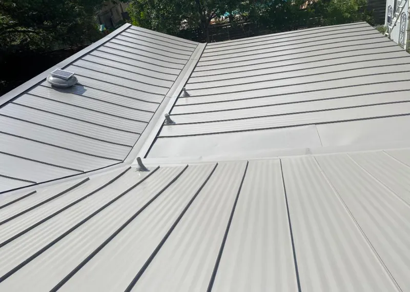 Solar attic fan installed on a metal roof for Roof Ventilation in Hoffman Estates